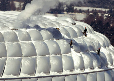 Workers remove snow from the newly built soccer stadium 'Allianz Arena' in the southern Bavarian tow..