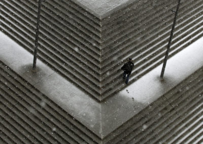 A man walks over snow-covered steps next to Berlin's central railway station