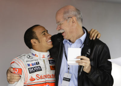 Hamilton is hugged by Zetsche Chairman of the Board of Management of Daimler AG