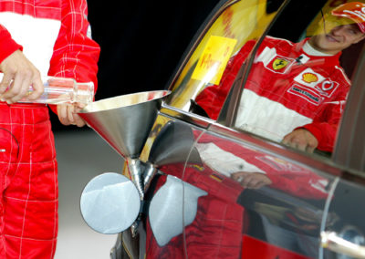 Michael Schuhmacher refills a car with new fuel