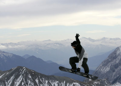 A snowboarder makes a jump on Zugspitze mountain